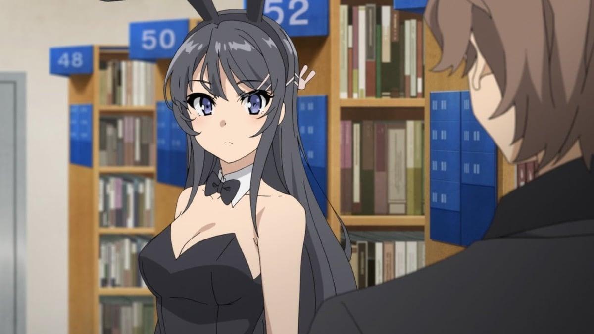 A girl dressed in bunny ears stares at a boy in a library